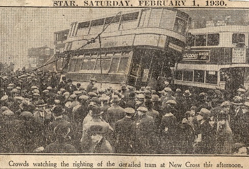 Newspaper cutting, a crowd of people next to a derailed tram in 1930